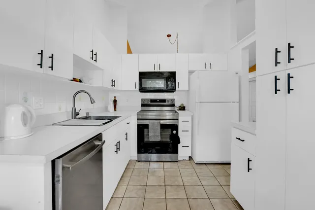 a bedroom with a bed and a dresser in it