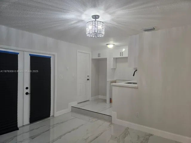 a view of a hallway with a chandelier