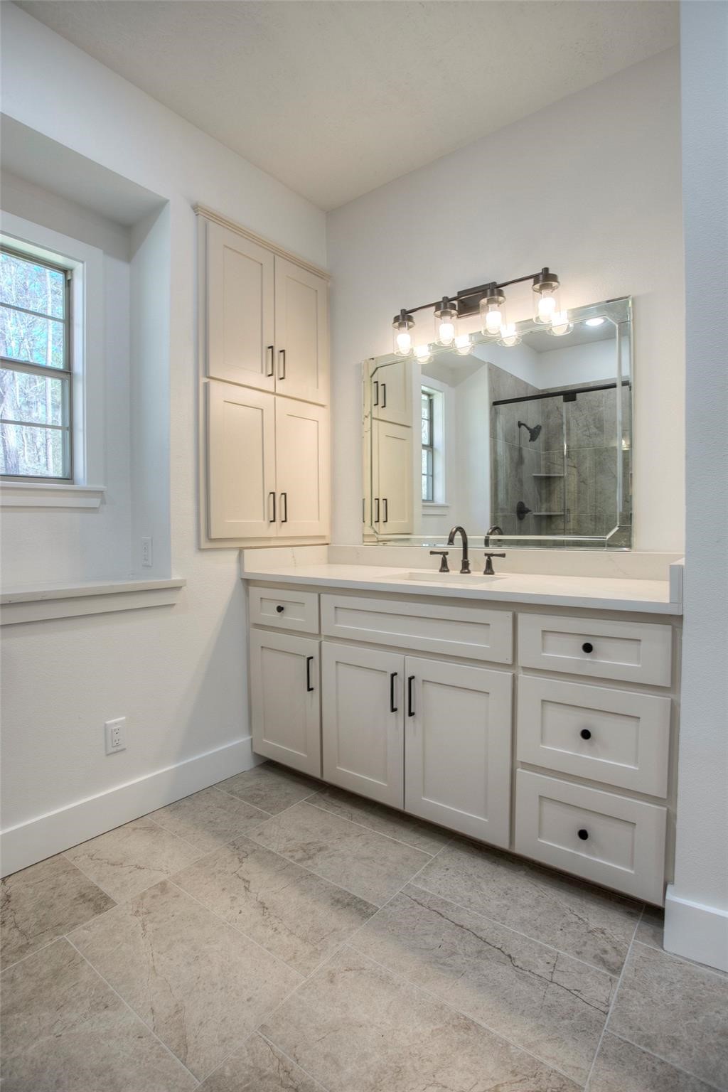 83 Dahlia Road Huntsville, TX 77320 - Photo 35 of 49 a spacious bathroom with a granite countertop sink and a mirror
