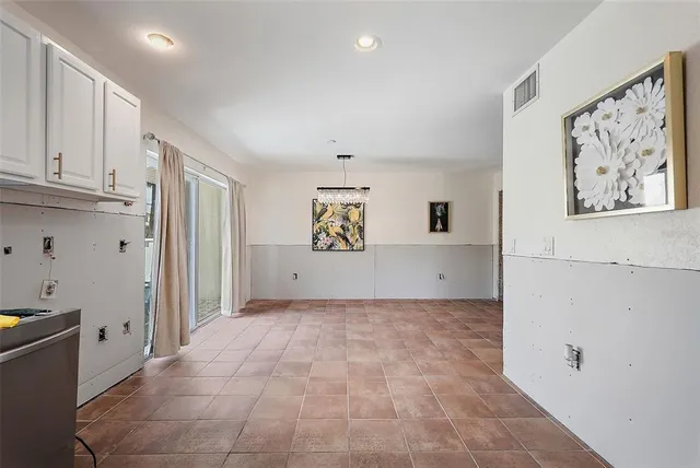 a view of a big room with window and cabinet