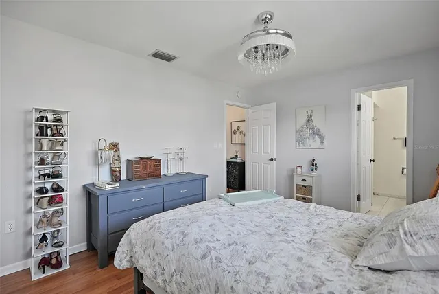a bedroom with a bed and a chandelier