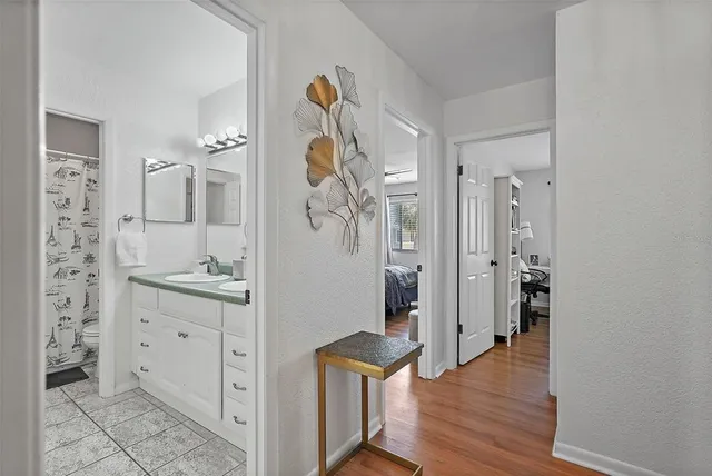 a view of bathroom with a sink mirror and shower