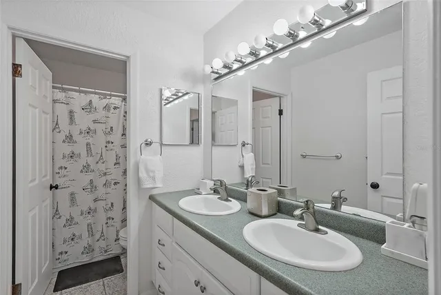 a bathroom with a sink double vanity and a mirror