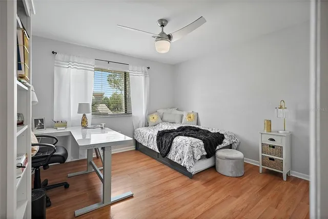 a bedroom with a bed and wooden floor