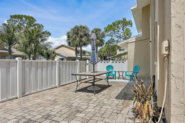 a view of a patio with table and chairs and potted plants
