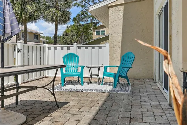 a view of a chairs and table in the balcony