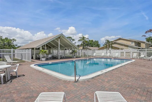 a view of houses with swimming pool and outdoor space