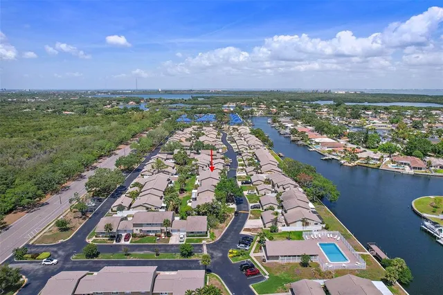 an aerial view of residential houses with outdoor space and street view