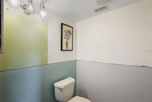 a white toilet sitting next to a bathroom sink