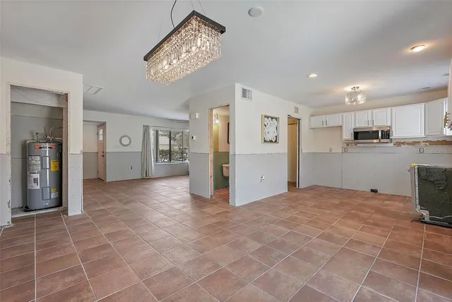 a view of a kitchen with refrigerator and windows