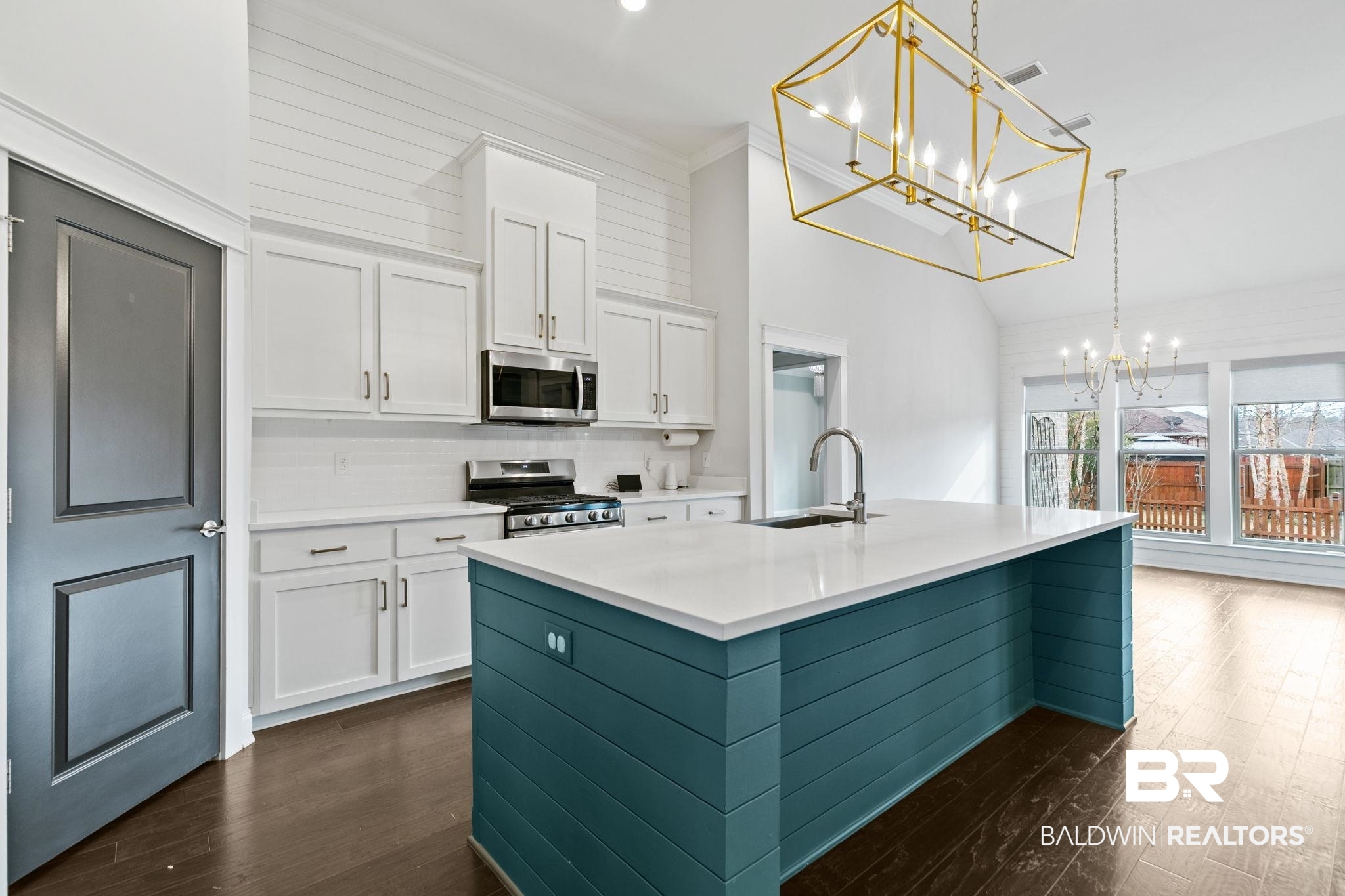 31654 Canopy Loop Daphne, AL 36527 - Photo 14 of 64 Kitchen featuring a kitchen island with sink, stainless steel appliances, crown molding, dark wood-type flooring, and a chandelier