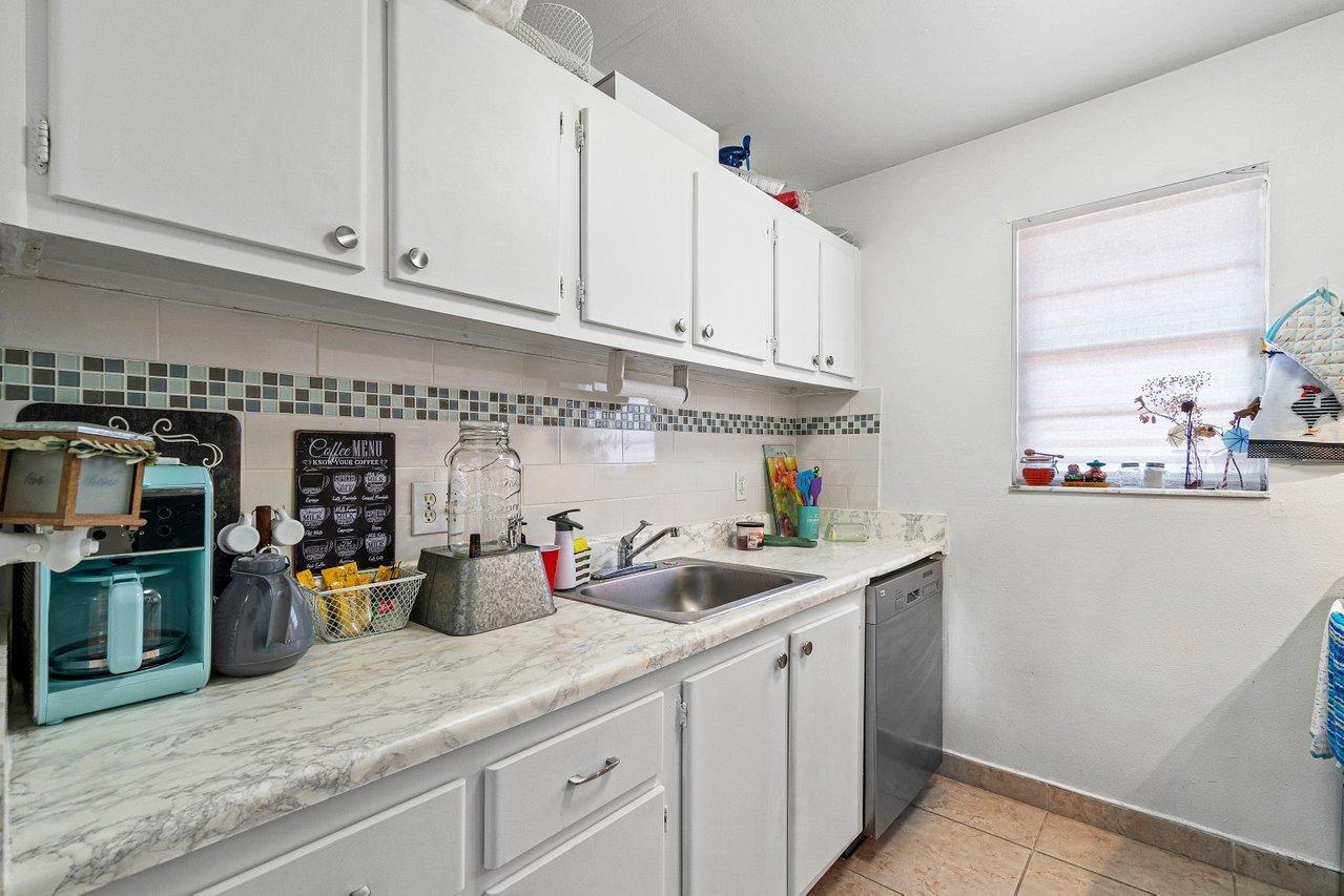 600 Southwest 2nd Street, Unit 2390 Boca Raton, FL 33486 - Photo 12 of 18 a kitchen with stainless steel appliances granite countertop a sink a stove and cabinets