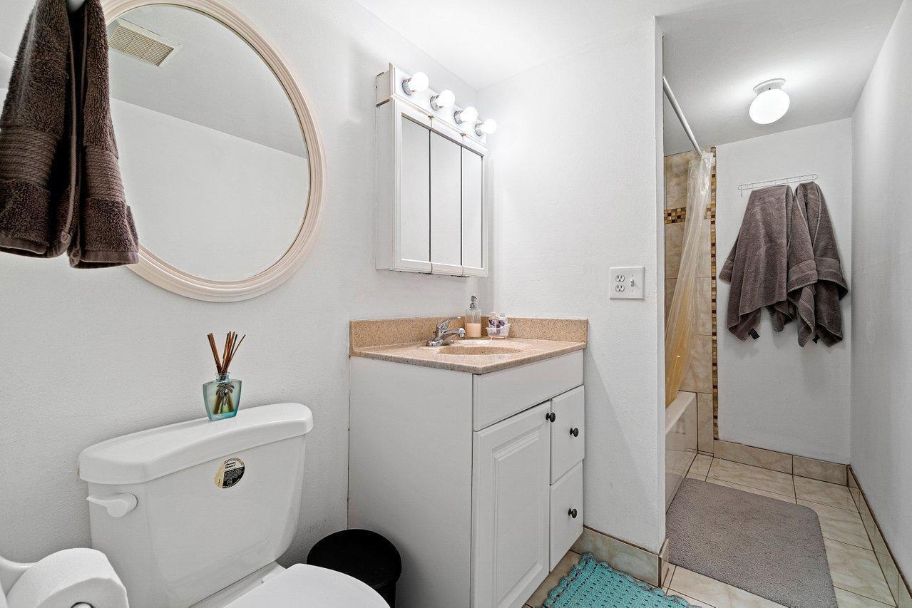 600 Southwest 2nd Street, Unit 2390 Boca Raton, FL 33486 - Photo 14 of 18 a bathroom with a toilet a sink and mirror