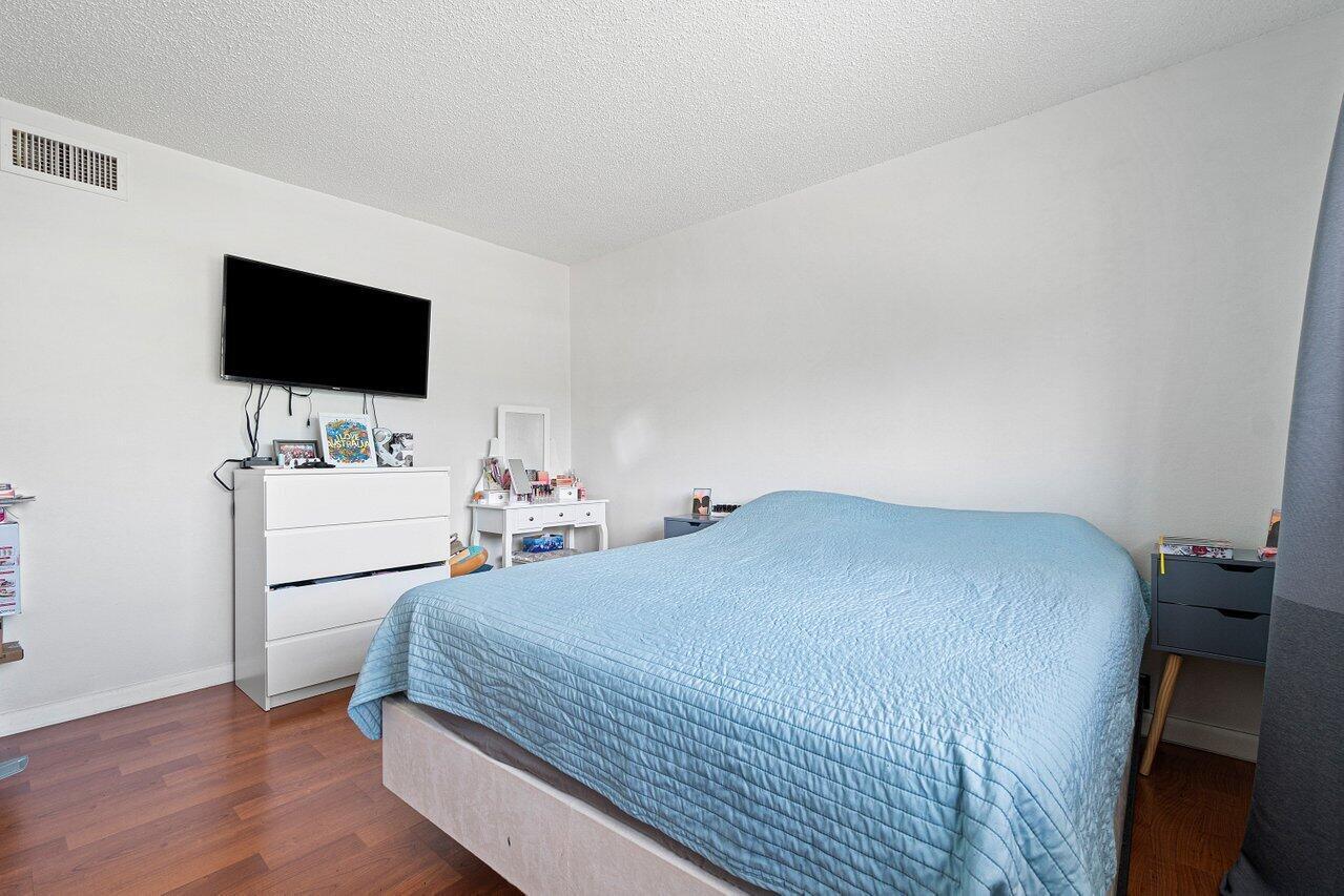 600 Southwest 2nd Street, Unit 2390 Boca Raton, FL 33486 - Photo 9 of 18 a bedroom with a bed and a flat screen tv