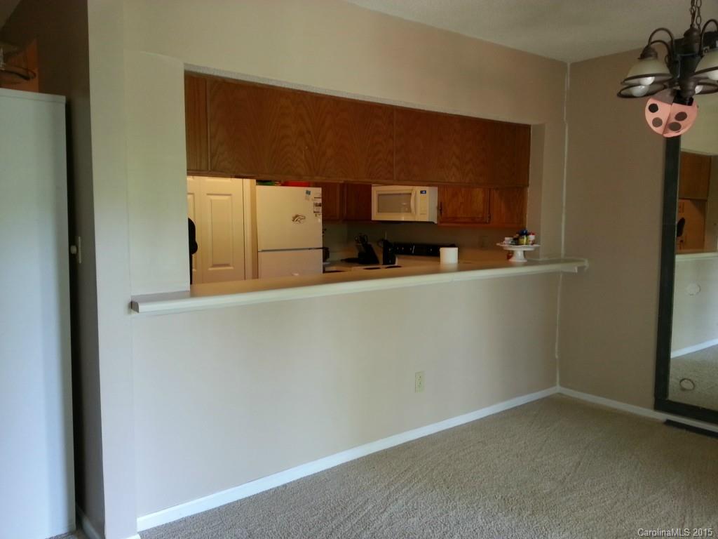20119 Henderson Road, Unit A Cornelius, NC 28031 - Photo 6 of 13 a kitchen with a refrigerator and a stove top oven