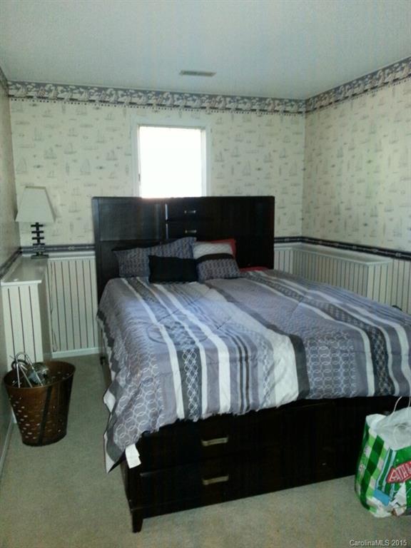 20119 Henderson Road, Unit A Cornelius, NC 28031 - Photo 10 of 13 a bedroom with a bed and a couch