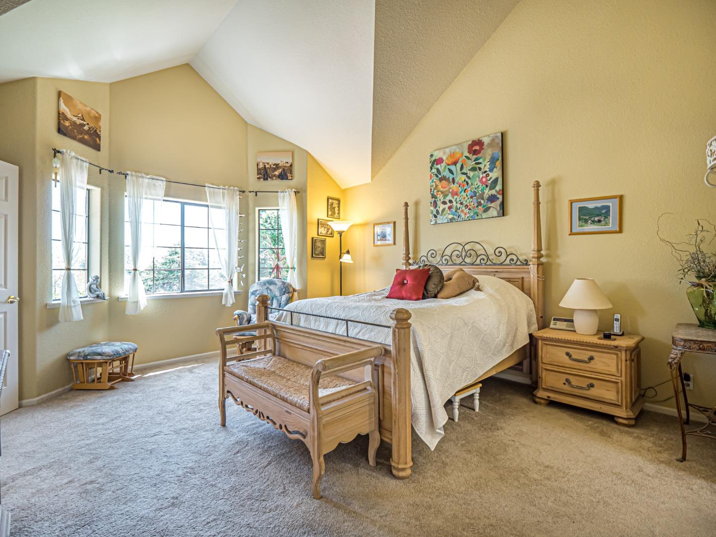 394 Hames Road Corralitos, CA 95076 - Photo 17 of 39 a spacious bedroom with a bed and a couch