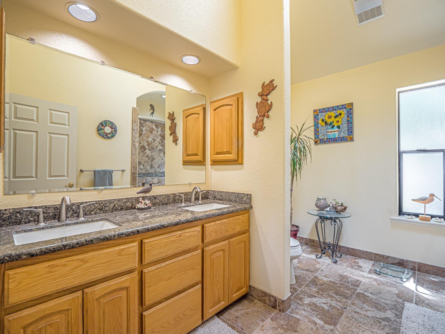 394 Hames Road Corralitos, CA 95076 - Photo 18 of 39 a bathroom with a granite countertop sink mirror and a