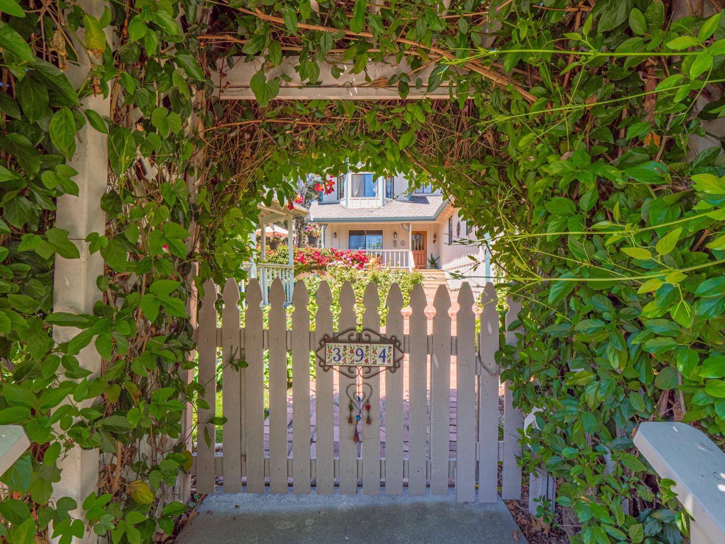 394 Hames Road Corralitos, CA 95076 - Photo 2 of 39 a view of a brick house with a tree in front