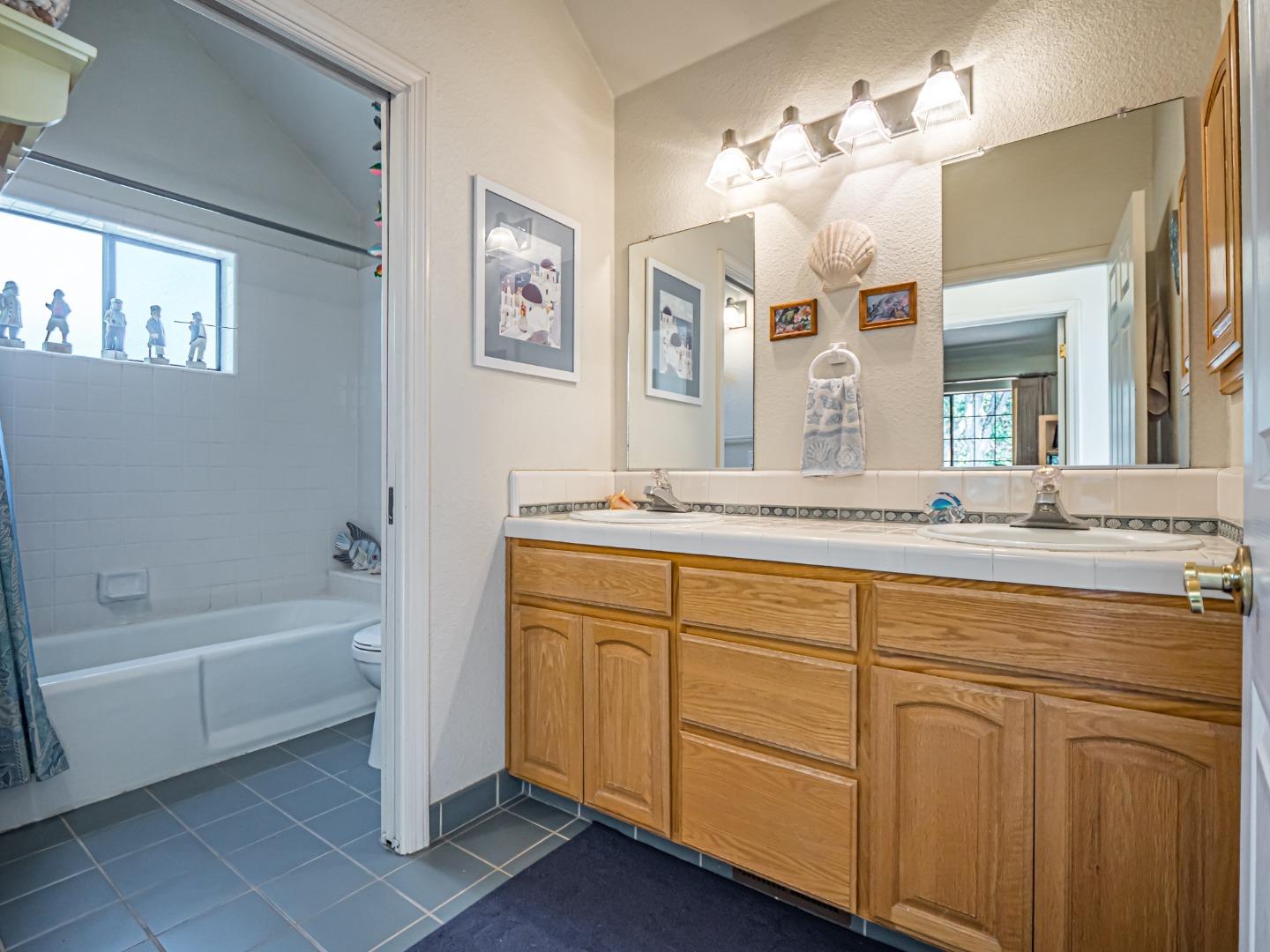 394 Hames Road Corralitos, CA 95076 - Photo 24 of 39 a bathroom with a granite countertop sink mirror and bathtub