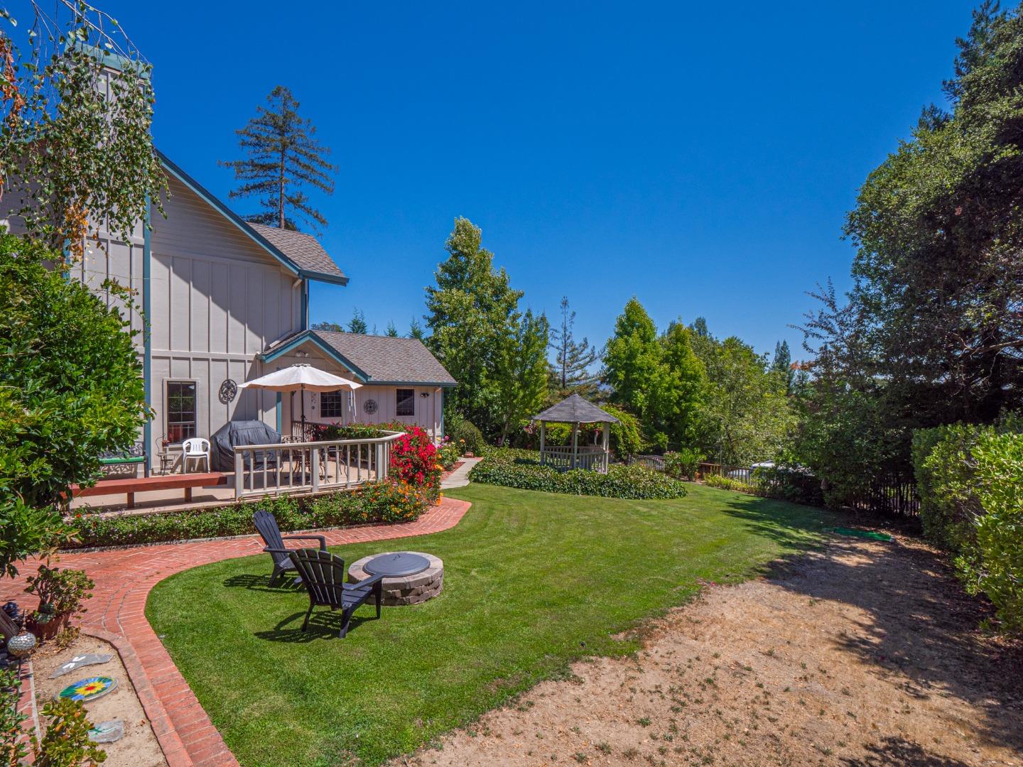 394 Hames Road Corralitos, CA 95076 - Photo 31 of 39 a front view of a house with a yard table and chairs
