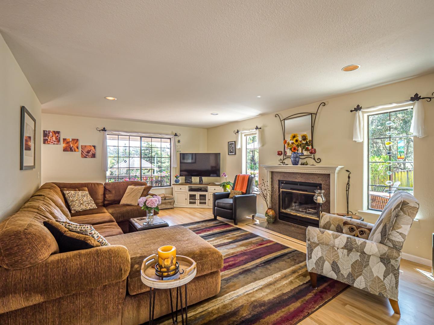 394 Hames Road Corralitos, CA 95076 - Photo 9 of 39 a living room with furniture a fireplace and a window