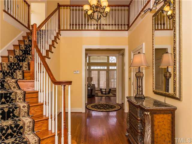 8677 Barrett Ridge Road Wake Forest, NC 27587 - Photo 2 of 25 The dramatic foyer welcomes you inside this fabulous home! Hardwood floors, extensive molding, and columns add to the architectural details found in this show-stopping home. Foyer