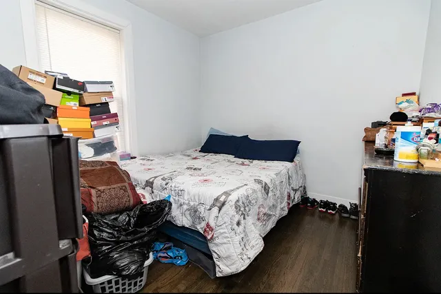 a bed sitting in a bedroom next to a window