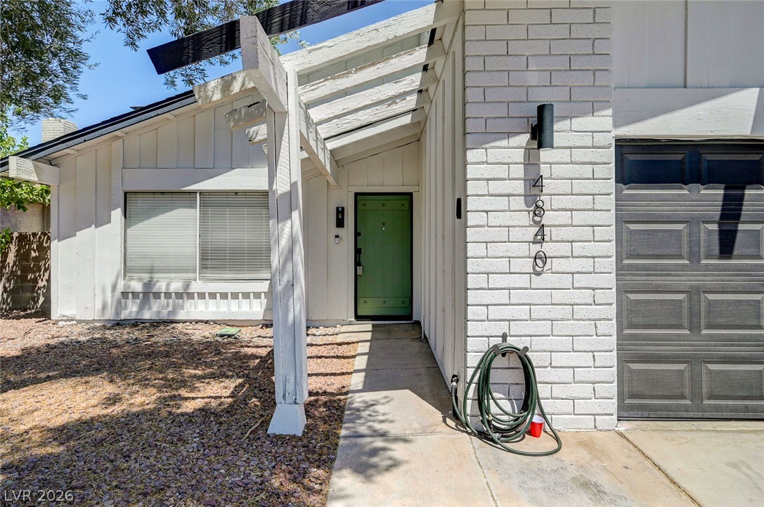 4840 Summerhill Road Las Vegas, NV 89121 - Photo 4 of 56 A welcoming entry, complete with a covered porch and an attached garage.