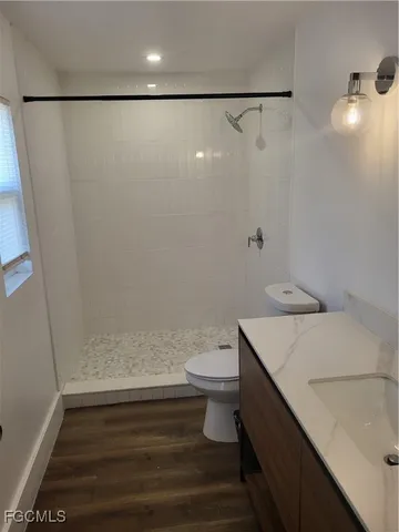 a bathroom with a sink a toilet and a shower