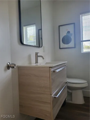 a bathroom with a toilet sink and mirror