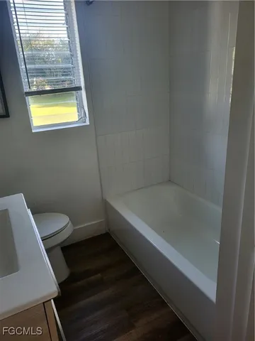 a bathroom with a bath tub and a window