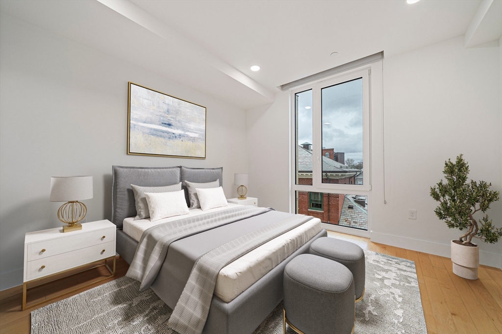 7 Beech Street, Unit 319 Cambridge, MA 02140 - Photo 11 of 27 a bedroom with a bed and a potted plant