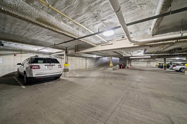 a view of parking garage with cars parked