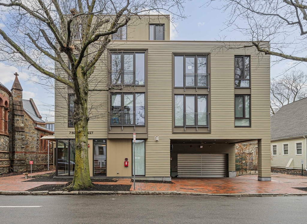 7 Beech Street, Unit 319 Cambridge, MA 02140 - Photo 26 of 27 a front view of a residential apartment building with a yard