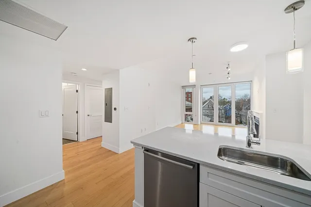 a kitchen with stainless steel appliances granite countertop a sink a refrigerator and a granite counter tops