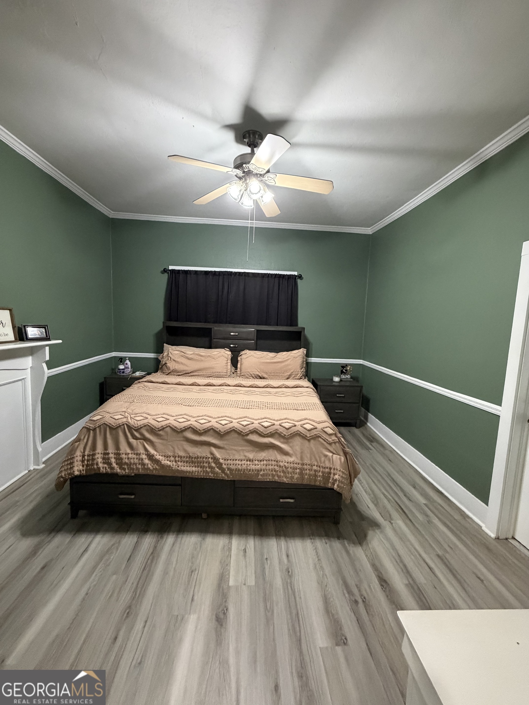 416 Bailey Street Valley, AL 36854 - Photo 21 of 24 a bedroom with a large bed and a chandelier