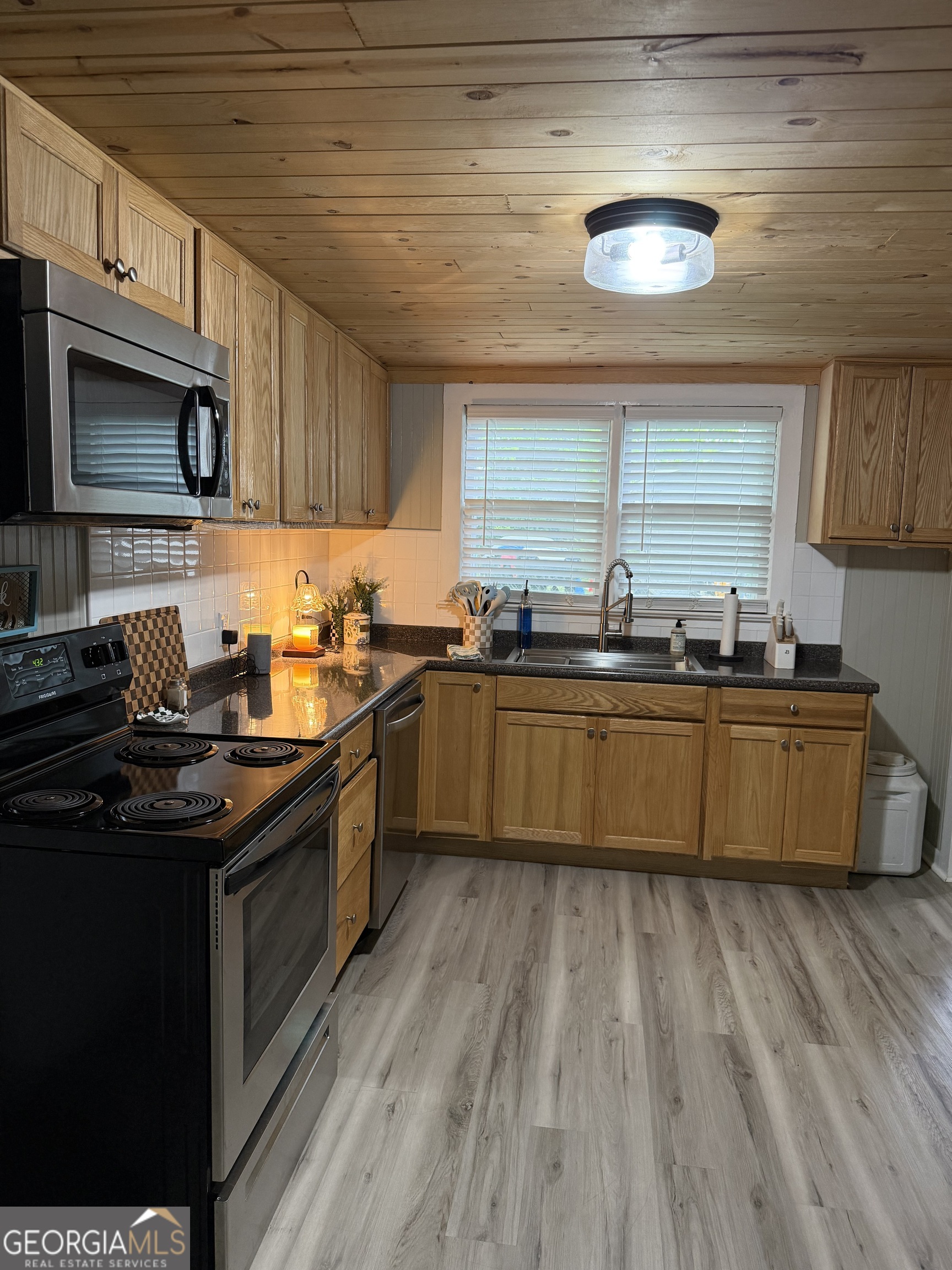 416 Bailey Street Valley, AL 36854 - Photo 8 of 24 a kitchen with stainless steel appliances granite countertop a sink a stove top oven a counter space and cabinets