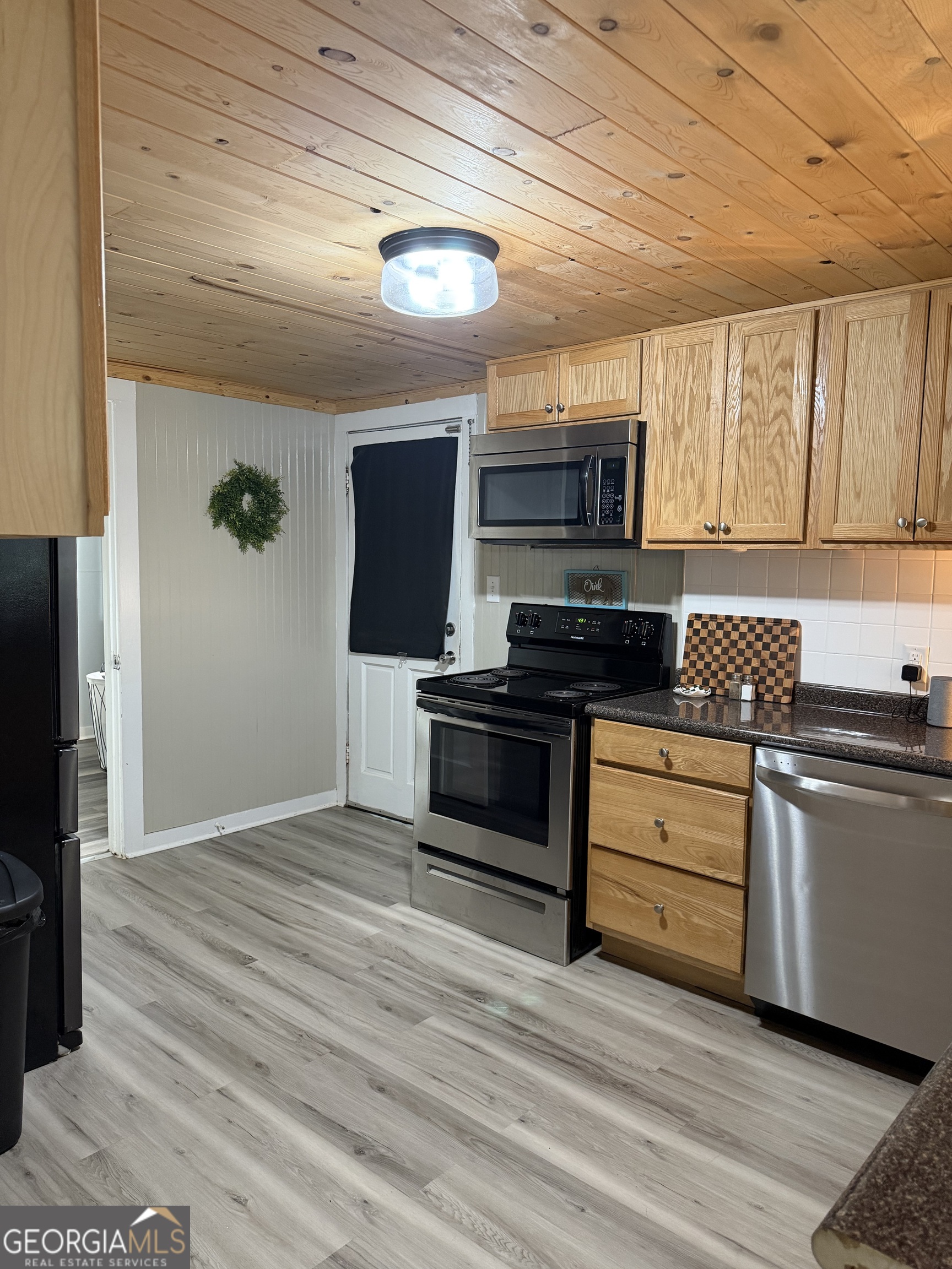 416 Bailey Street Valley, AL 36854 - Photo 9 of 24 a kitchen with stainless steel appliances kitchen island granite countertop a stove a sink and a microwave