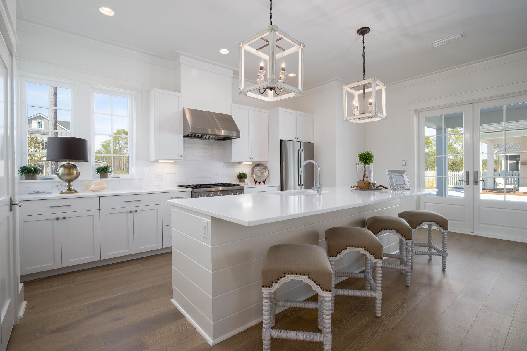 46 Catface Dr Inlet Beach, Unit LOT 178 Inlet Beach, FL 32461 - Photo 3 of 19 a open kitchen with stainless steel appliances granite countertop a stove a sink dishwasher a dining table and chairs with wooden floor