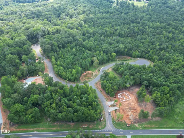 an aerial view of a house with yard