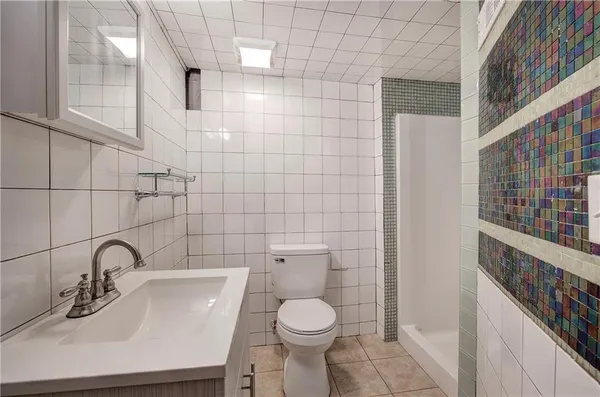 a bathroom with a toilet sink and a mirror