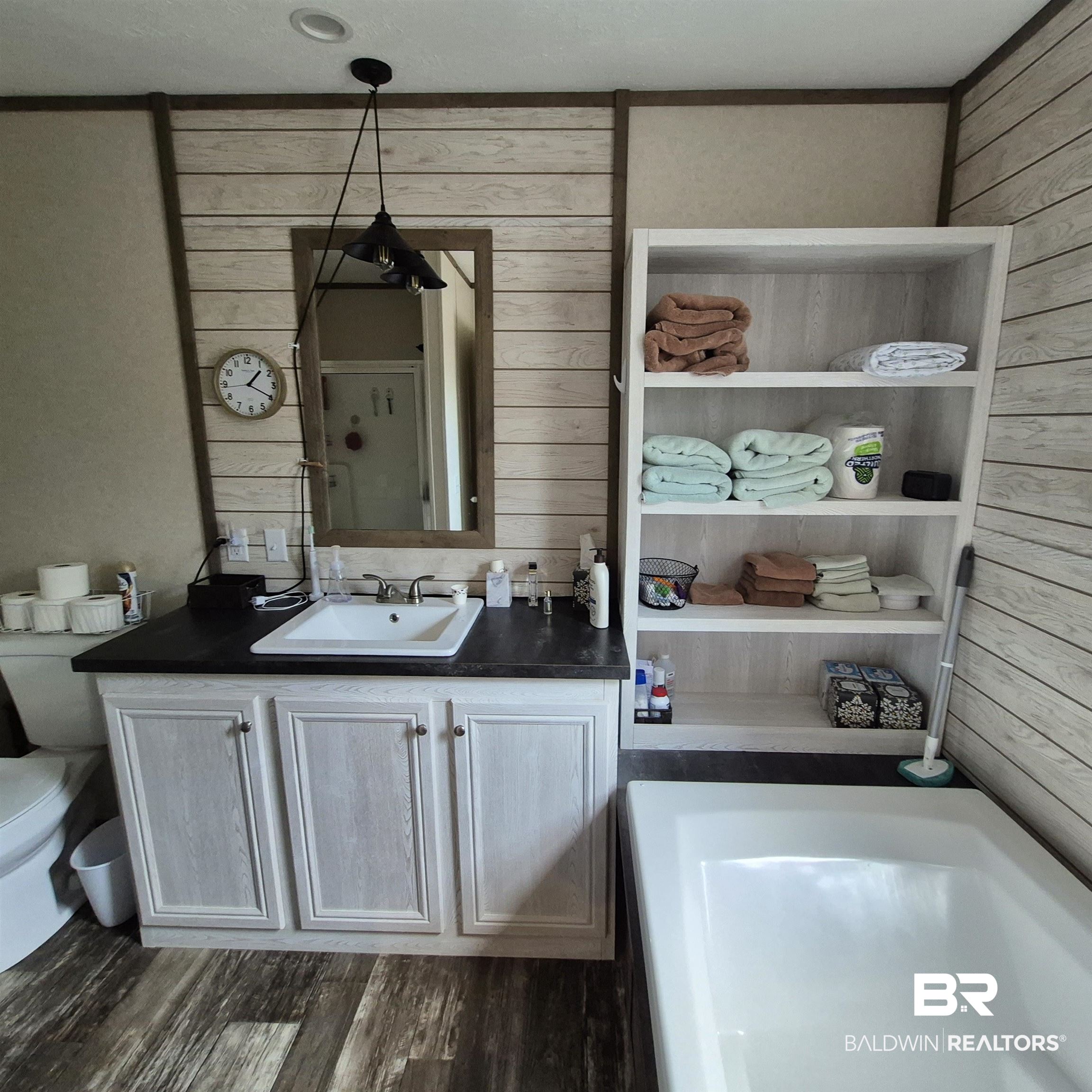 4790 Brooklyn Road Evergreen, AL 36401 - Photo 14 of 30 Full bath with vanity, a bath, wooden walls, and dark wood finished floors