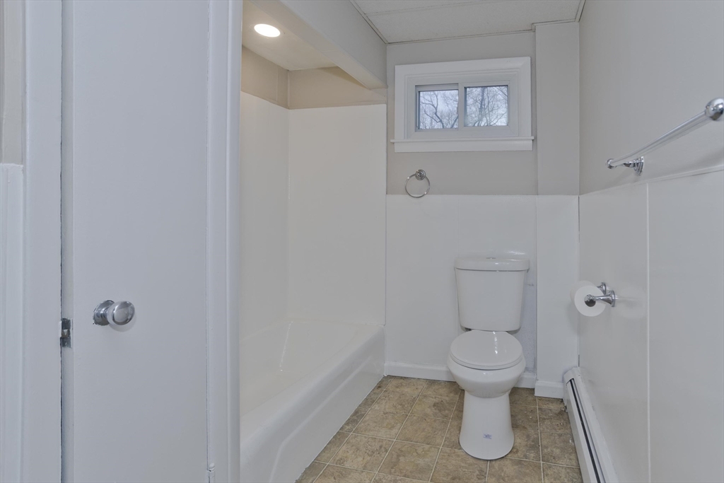 177 Marion Street Chicopee, MA 01013 - Photo 17 of 36 a bathroom with a toilet and a window