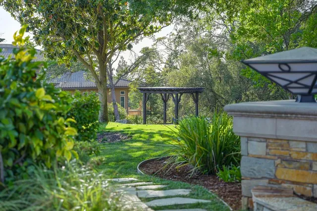 a view of a house with backyard and sitting area