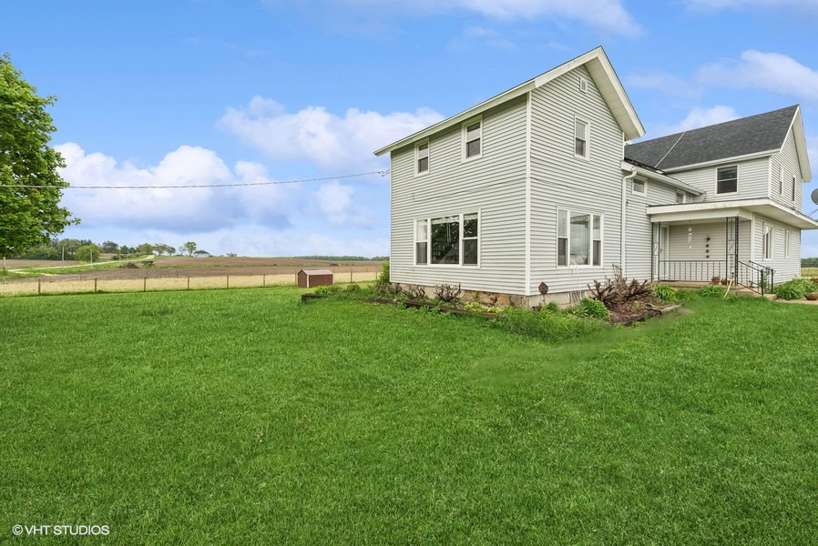 11719 Engelhardt Road Harvard, IL 60033 - Photo 1 of 18 a front view of a house with garden