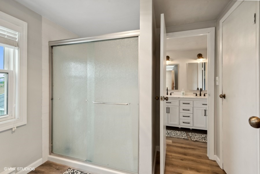 11719 Engelhardt Road Harvard, IL 60033 - Photo 11 of 18 a bathroom with a shower and a mirror