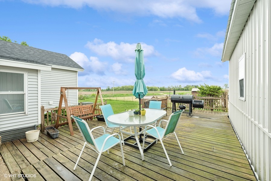 11719 Engelhardt Road Harvard, IL 60033 - Photo 14 of 18 a balcony with wooden floor table and chairs