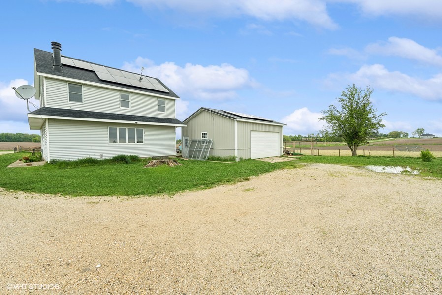 11719 Engelhardt Road Harvard, IL 60033 - Photo 15 of 18 a view of a house with a big yard and large trees