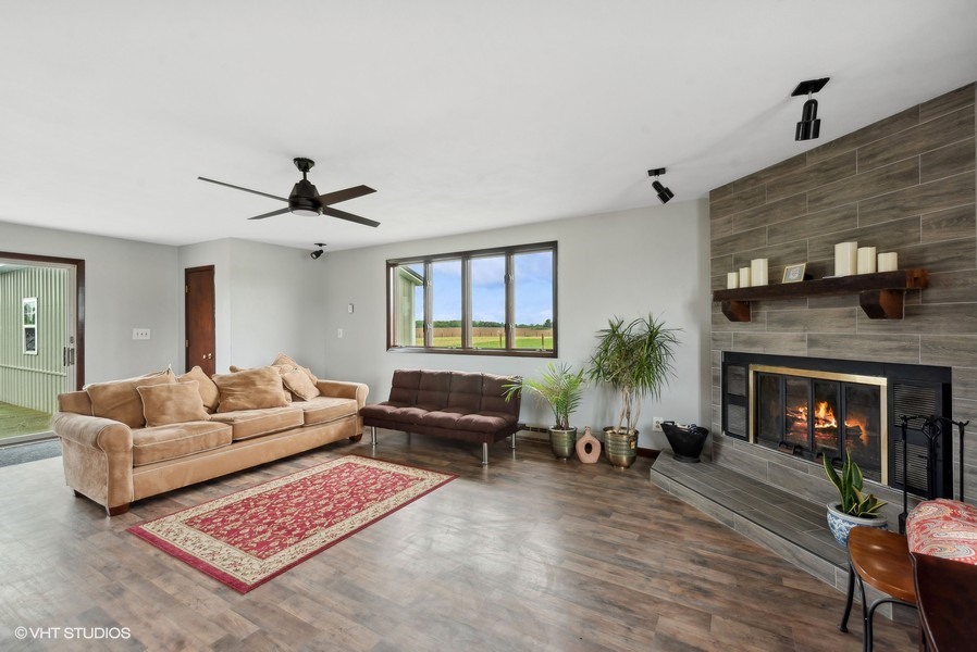 11719 Engelhardt Road Harvard, IL 60033 - Photo 7 of 18 a living room with furniture and a fireplace